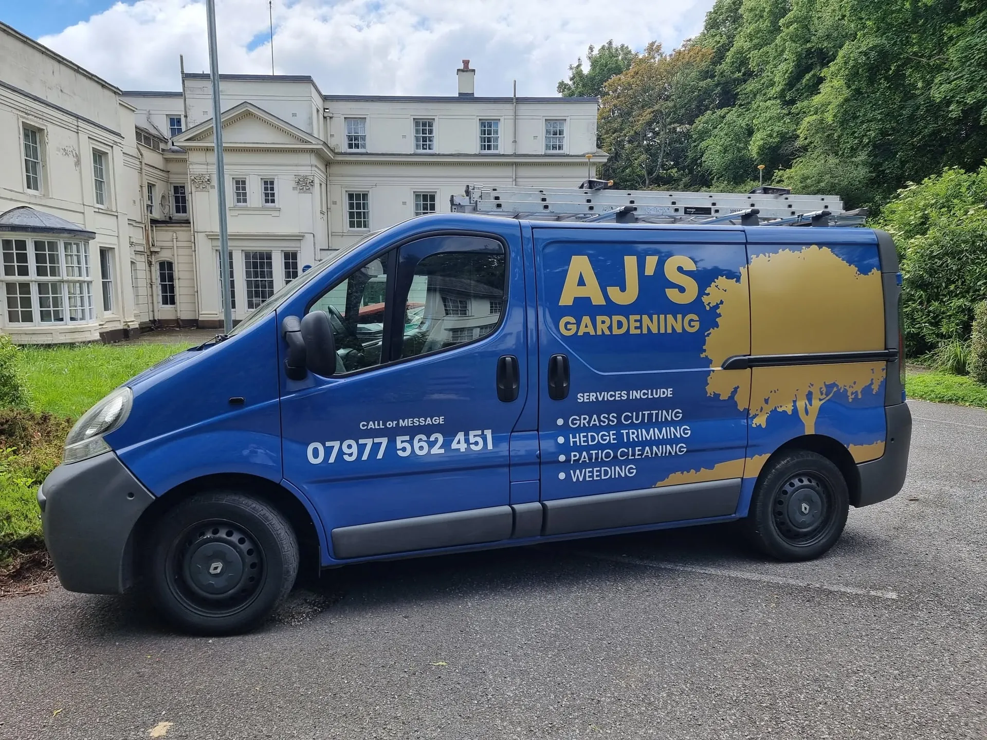 Blue van with full-colour livery for a local gardening business, contact details and services on the side panel
