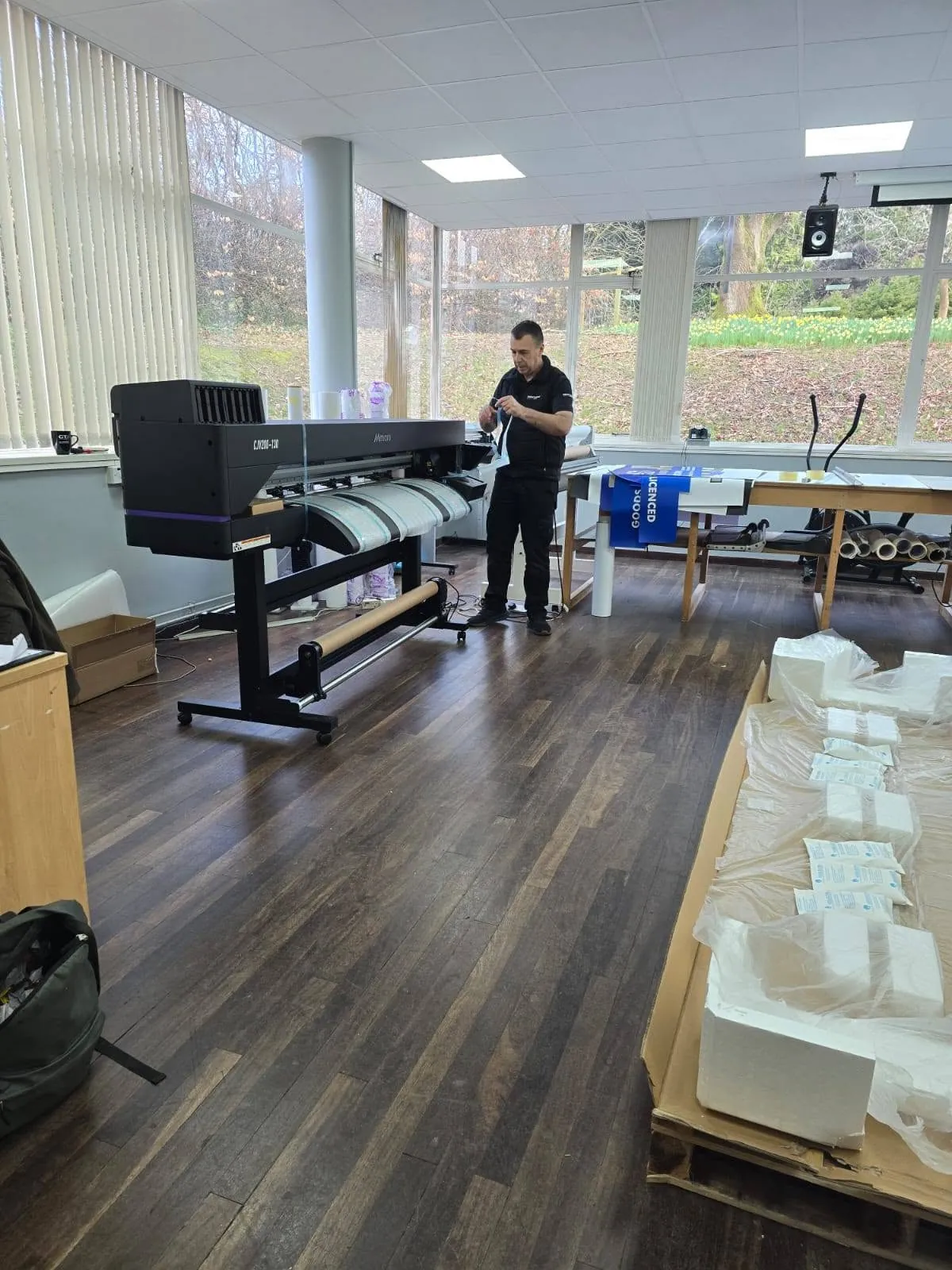 Large-format printer running in the Abbey Signs studio at Woodbrooke, Bournville