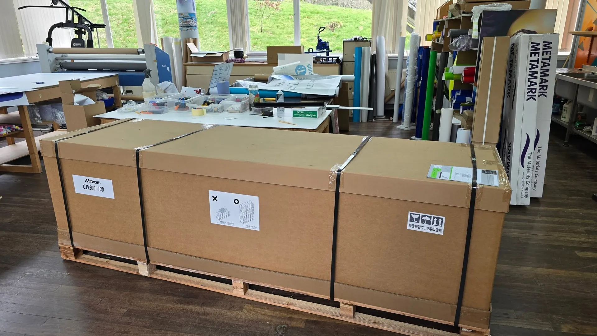 Finished signage panels boxed on pallets in the Abbey Signs workshop, ready for installation