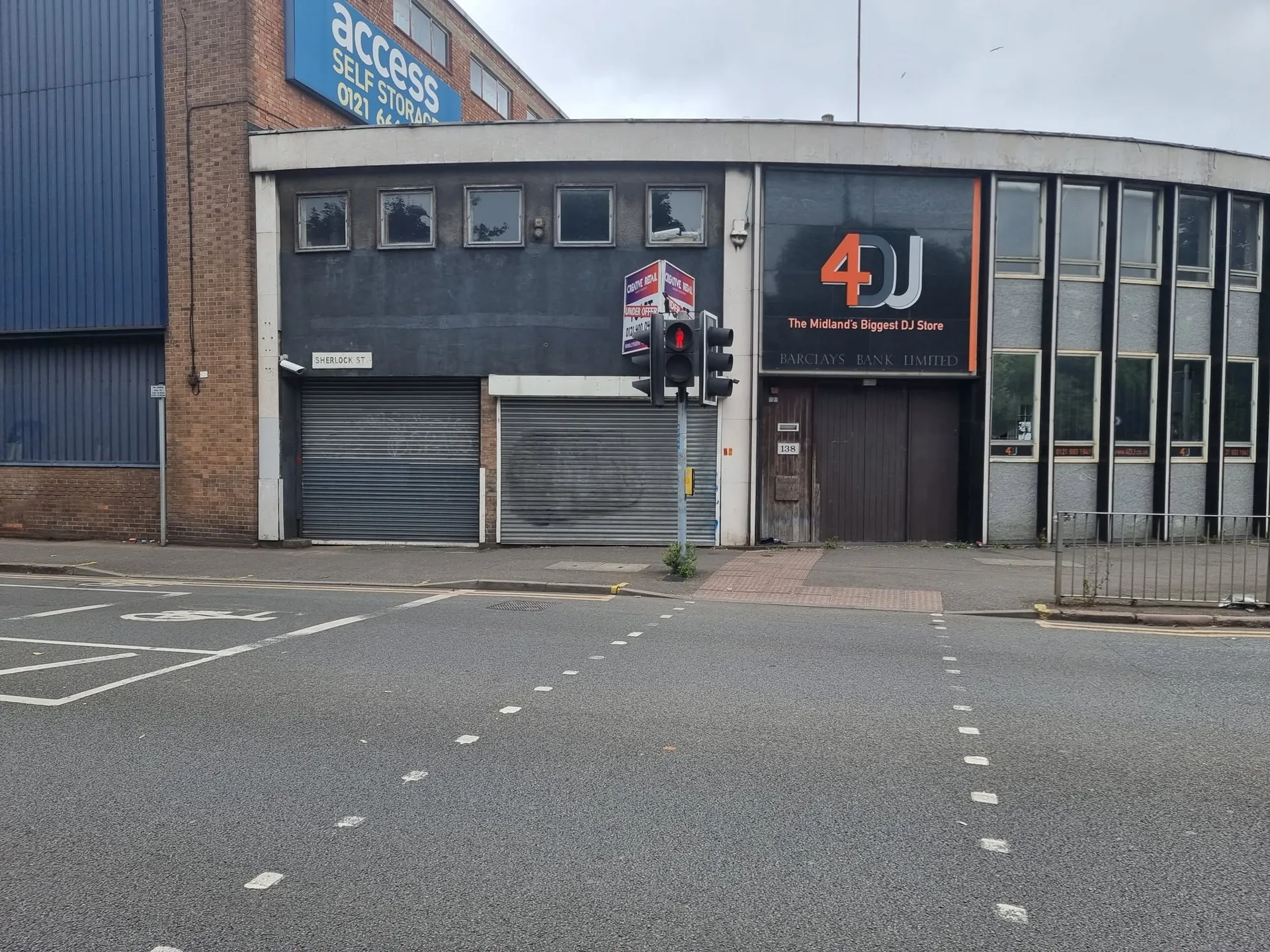 Corner commercial building before its new window and wall graphics
